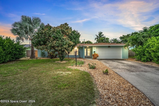 view of front of property featuring a lawn and a garage