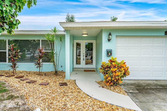 doorway to property featuring french doors and a garage