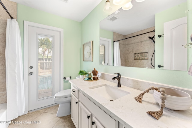 bathroom featuring tile patterned flooring, vanity, and toilet