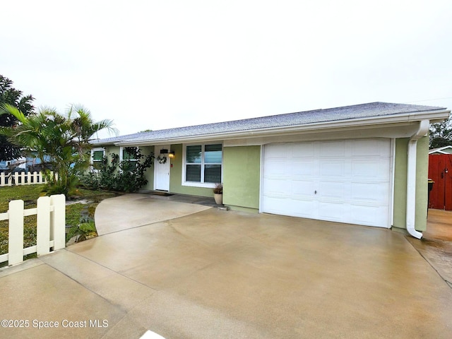 ranch-style house with a garage, driveway, fence, and stucco siding