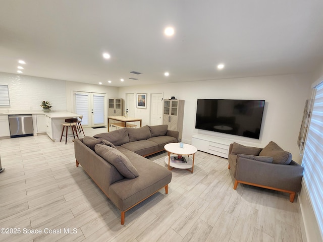 living room with visible vents, light wood-style flooring, and recessed lighting