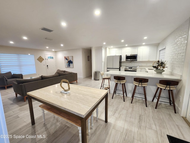 living room with recessed lighting and visible vents