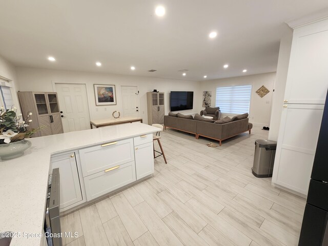 kitchen featuring white cabinetry, light countertops, and recessed lighting