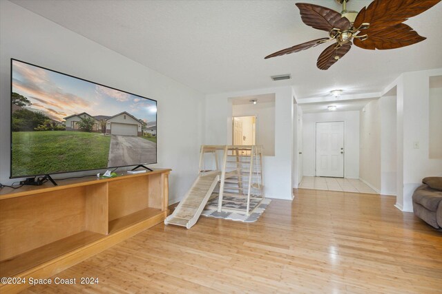 misc room with light wood-type flooring and ceiling fan