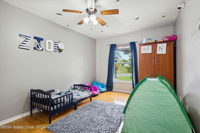 bedroom featuring ceiling fan and hardwood / wood-style floors