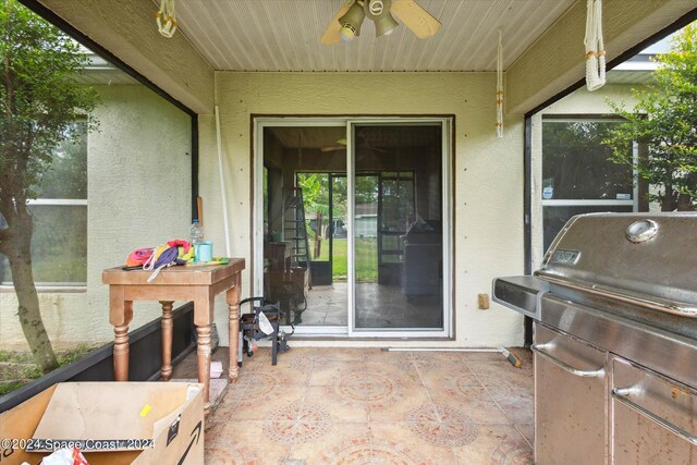 view of patio with area for grilling and ceiling fan