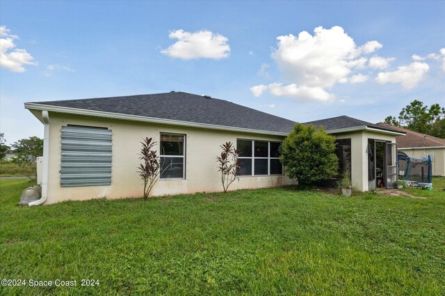 rear view of house with a yard