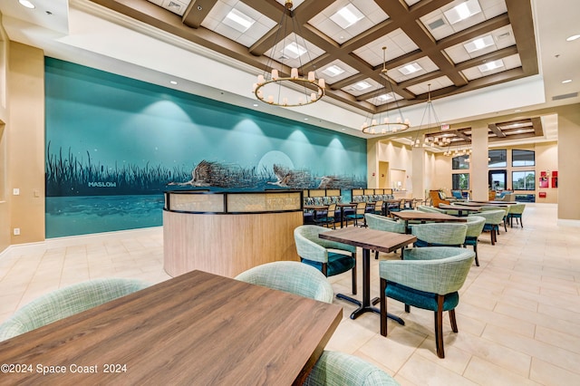 tiled dining area featuring coffered ceiling, a notable chandelier, and a towering ceiling