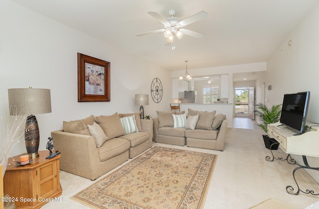 living room featuring light carpet and ceiling fan