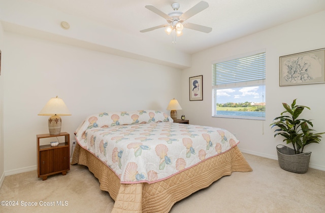 bedroom with ceiling fan and light colored carpet