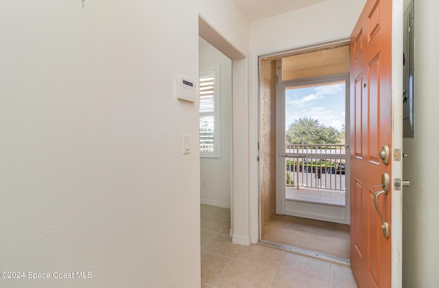 doorway with light tile patterned floors