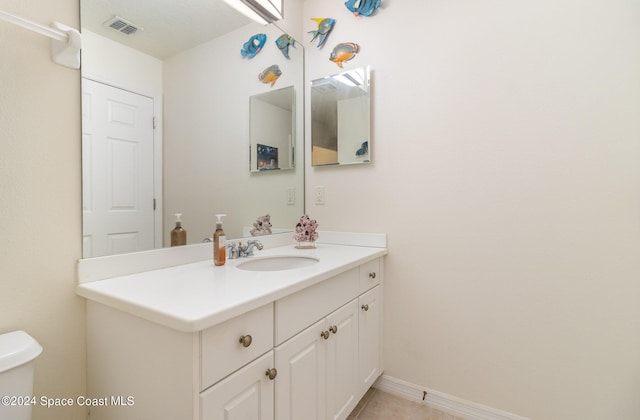 bathroom featuring vanity and toilet