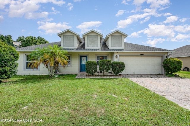 view of front of property featuring a front yard and a garage