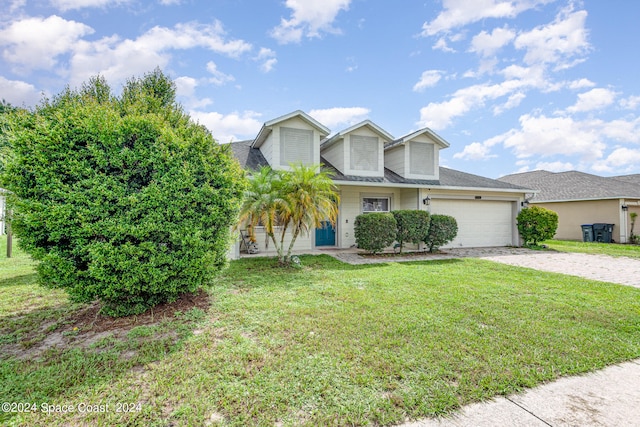 view of front of property featuring a garage and a front yard