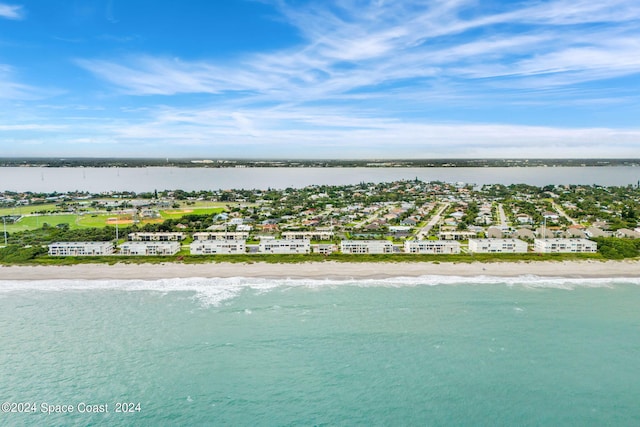 bird's eye view with a water view and a beach view