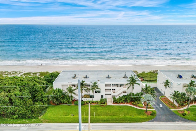 drone / aerial view with a beach view and a water view