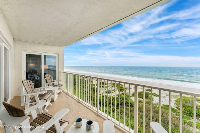 balcony with a beach view and a water view