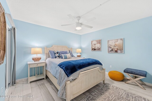 bedroom with ceiling fan and light hardwood / wood-style floors