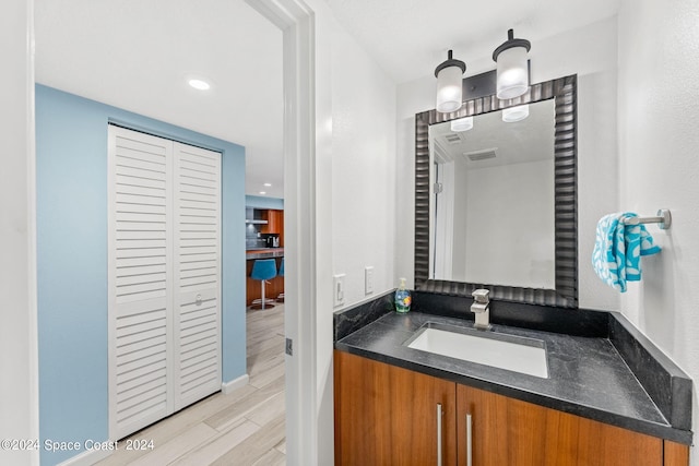 bathroom featuring hardwood / wood-style flooring and vanity