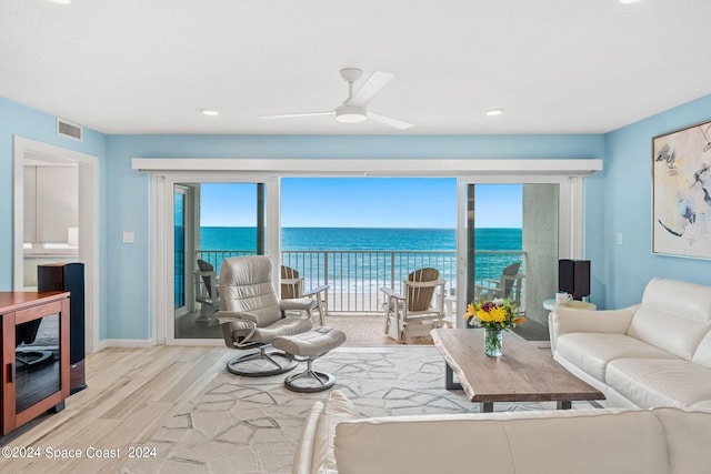 living room featuring a water view, ceiling fan, beverage cooler, and light hardwood / wood-style flooring