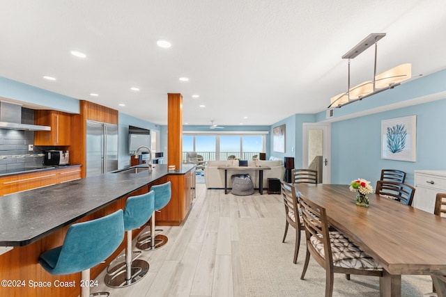 dining room with light hardwood / wood-style flooring and sink