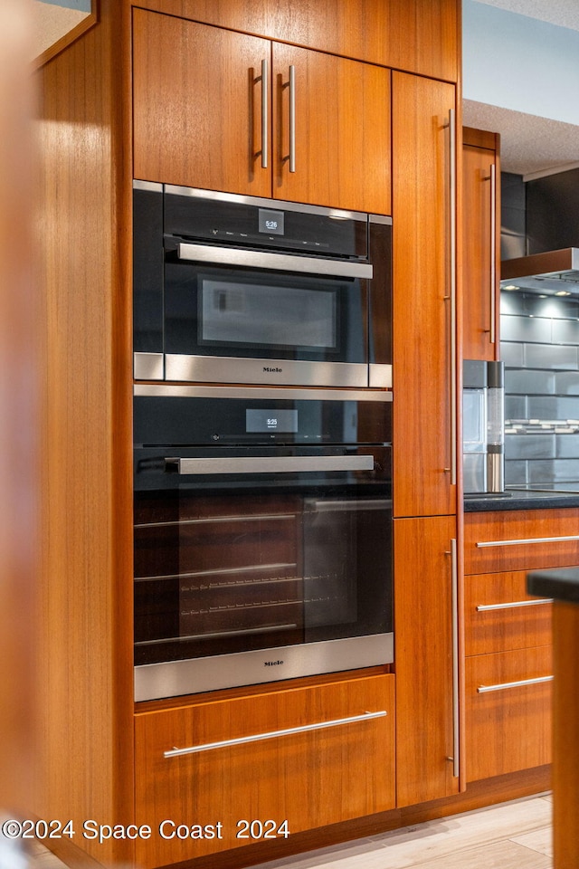 kitchen with light hardwood / wood-style flooring and double oven