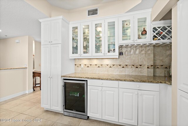 kitchen featuring white cabinets, light tile patterned floors, and wine cooler