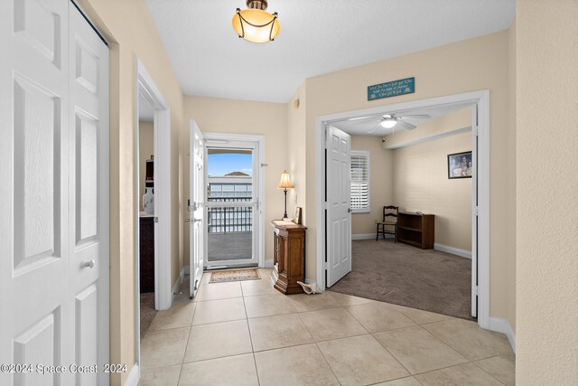 hallway with light tile patterned floors