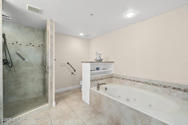 bathroom with tile patterned flooring, toilet, shower with separate bathtub, and a textured ceiling