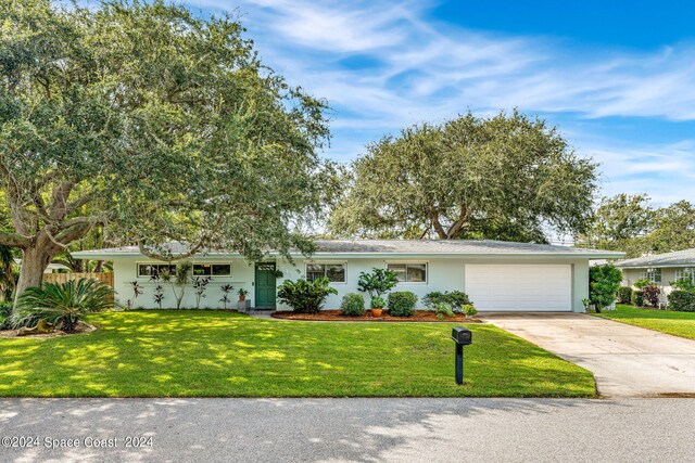 ranch-style house with a garage and a front yard