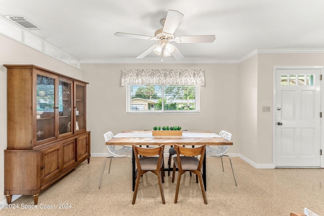 dining area featuring ceiling fan, plenty of natural light, and ornamental molding