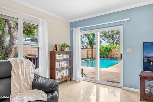 sitting room featuring a wealth of natural light and ornamental molding