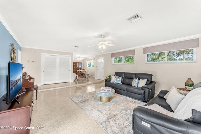 living room with ceiling fan and ornamental molding