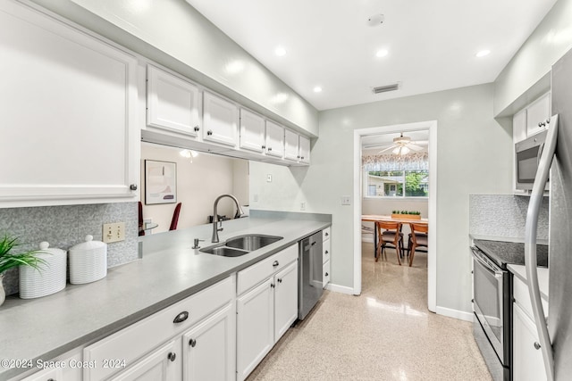 kitchen with stainless steel appliances, sink, ceiling fan, and white cabinetry