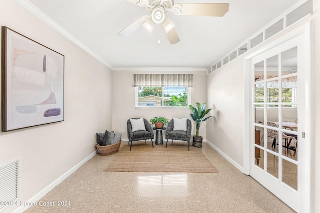 living area with crown molding and ceiling fan