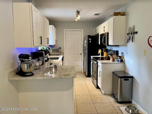 kitchen with white cabinetry, light stone counters, appliances with stainless steel finishes, and sink