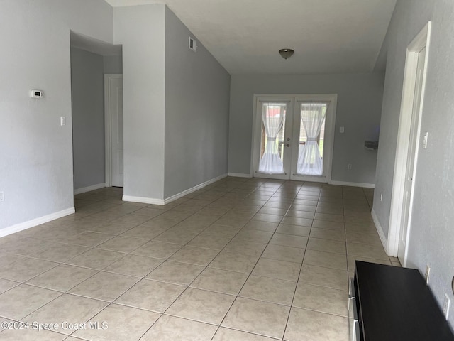 spare room with french doors and light tile patterned floors