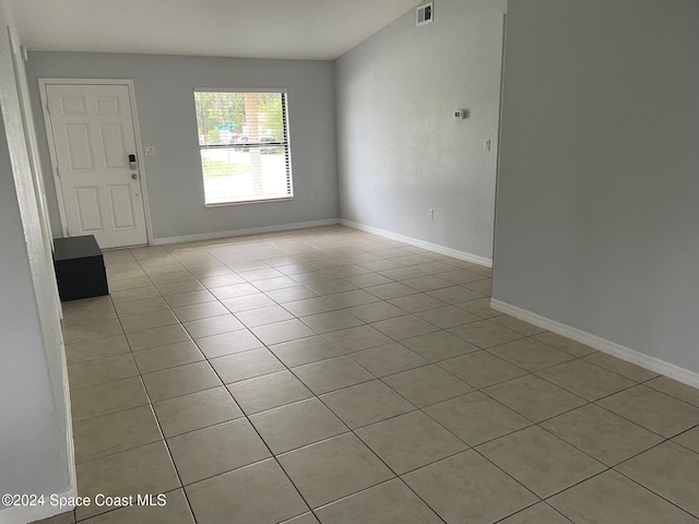 spare room featuring light tile patterned flooring