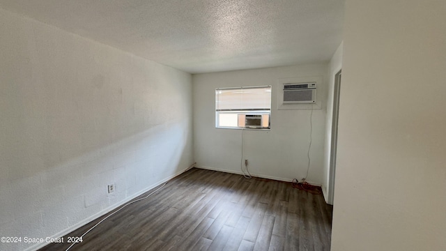 1715 Dixon Blvd Unit 121, Cocoa, FL 32922 - empty room with wood finished floors, a wall mounted air conditioner, and a textured ceiling