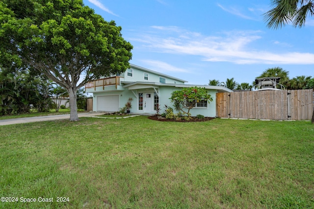 view of front of house with a front yard and a garage