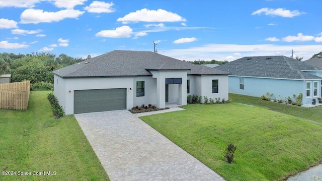 view of front of property with stucco siding, roof with shingles, an attached garage, decorative driveway, and a front lawn