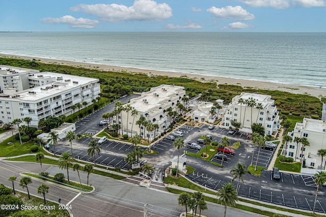 birds eye view of property with a water view and a view of the beach