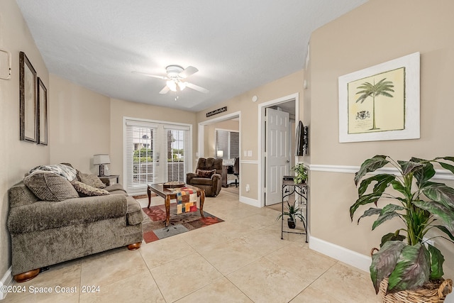 tiled living room with a textured ceiling and ceiling fan