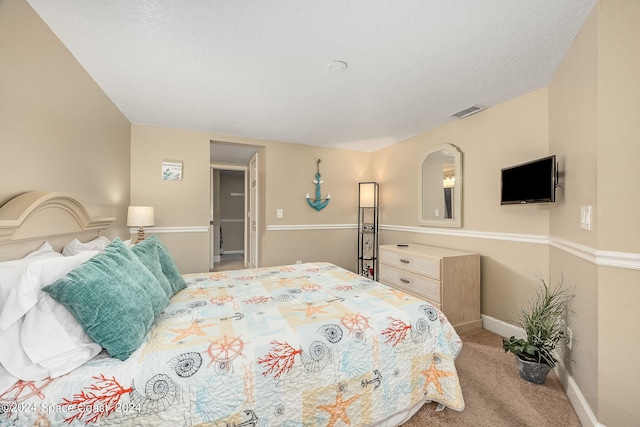 carpeted bedroom featuring a textured ceiling