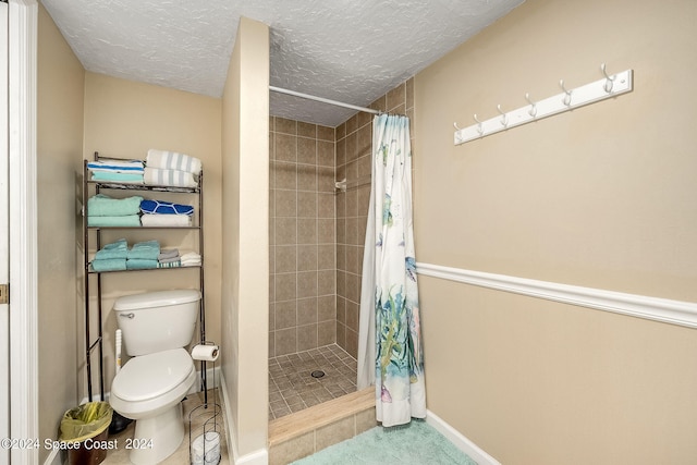 bathroom featuring a textured ceiling, toilet, and curtained shower