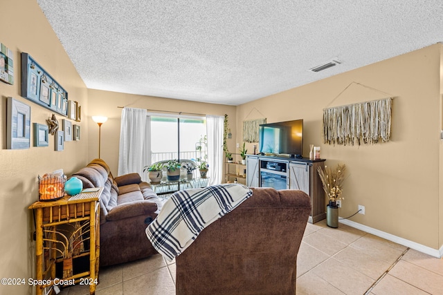 tiled living room featuring a textured ceiling