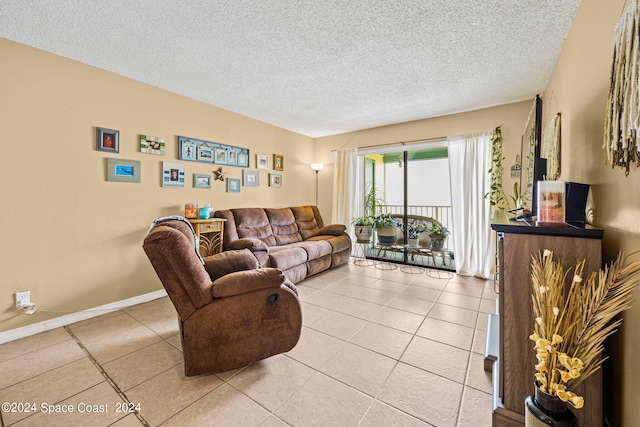 living room featuring a textured ceiling and light tile patterned floors