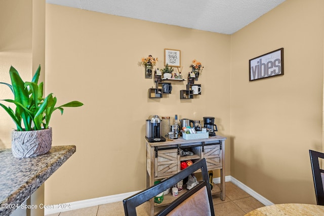 interior details featuring a textured ceiling and tile patterned flooring