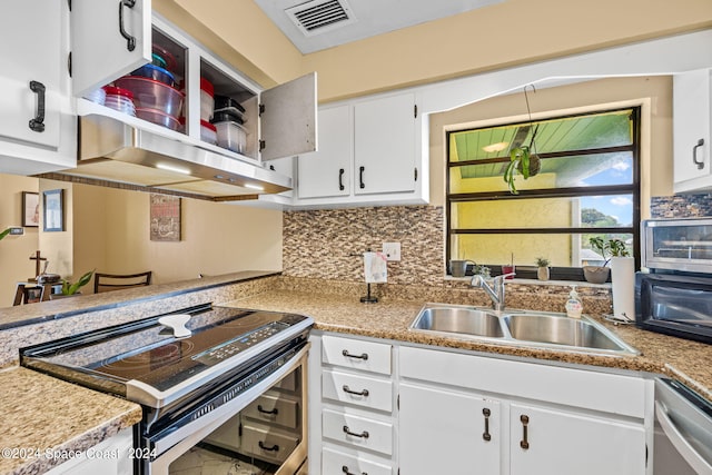 kitchen featuring decorative backsplash, stainless steel appliances, white cabinets, and sink