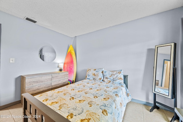 tiled bedroom with a textured ceiling